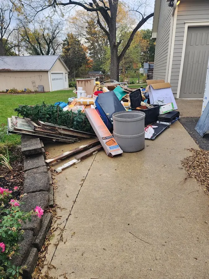 Dumpster being loaded with debris for Estate Cleanout Dumpster Rental in Bonanza